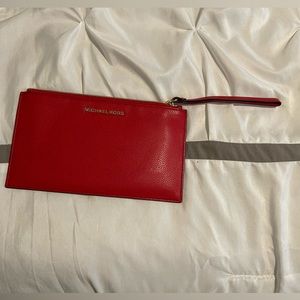Michael kors wristlet RED with gold accents.